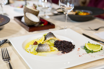Baked fillet of Dorado fish with garnish of red rice