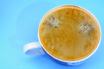 A cup of coffee on a blue background