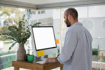 Side view of designer using computer