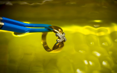 The jeweler washes the ring in an ultrasonic bath.