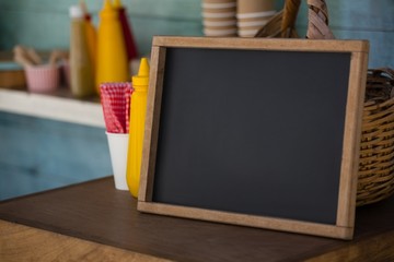 Writing slate on wooden table in food truck