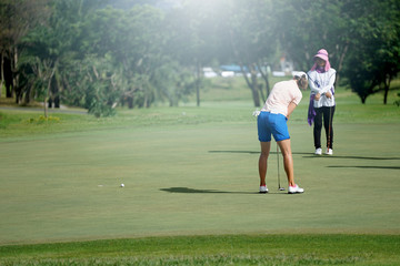 Woman golf is a sport requiring heat tolerance.