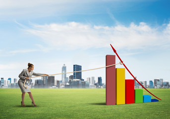 Businesswoman pulling graph with rope as concept of power and control