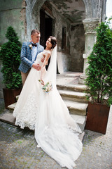 Flawless wedding young couple walking on city streets on a sunny day.