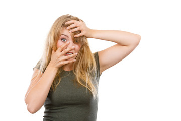 Ashamed embarrassed blonde woman with hands on face