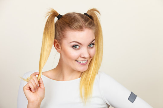 Happy blonde teenager girl with ponytails