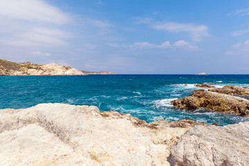 Fototapeta na wymiar Rocky coast and turquoise sea water in Mandrakia village on Milos island. Greece.