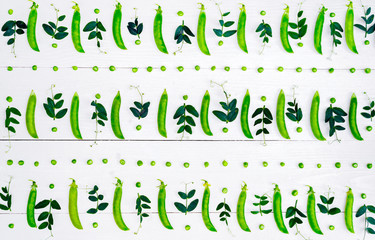 Top view of fresh green peas, pods and pea leaves on white background, free space, Food background, flat lay