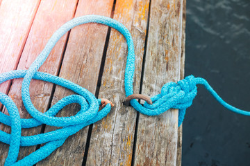Marine rope on wooden background
