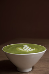 ceramic cup of green tea latte