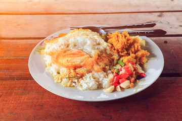 Fried rice with fried egg on table