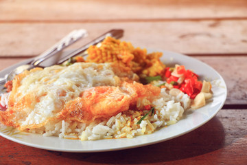 Fried rice with fried egg on table