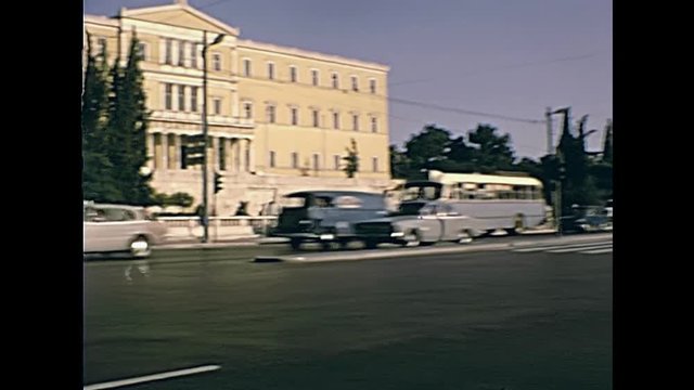 The Greek Hellenic parliament of Athens by the Leoforos Vasilissis Sofias street with vintage cars traffic in Greece. Restored historical 70s archival footage on circa 1972.