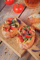 Bruschetta with chopped tomatoes, basil and herbs on grilled crusty bread.