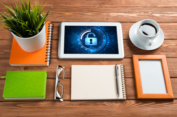 Web security and technology concept with tablet pc on wooden table