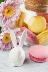 Fototapeta na wymiar Yellow and pink macaroons, decorative rabbit