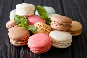 Beautiful colored macaroons in the assortment, close-up on the table. Horizontal