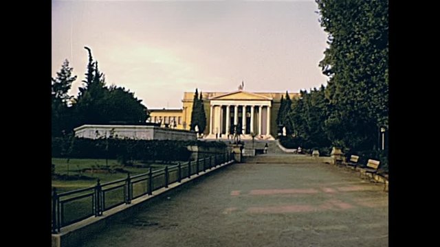The Greek Zappeion in Athens with Greek flag, a building for meetings and ceremonies in the National Gardens of Athens in Greece. Restored historical 70s archival footage on circa 1972.