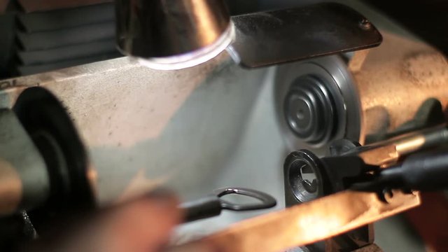 The master makes a key on professional equipment