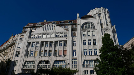 Fototapeta na wymiar Art nouveau building in the center of budapest. Beautiful building against the blue sky.