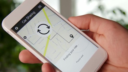 Man requests car using car sharing application on the smartphone and waits for the driver
