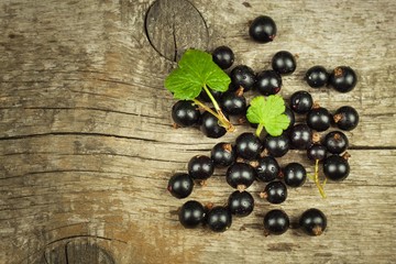Fresh black currant on a wooden table. Healthy fruit, full of vitamins and antioxidants. Healthy food.