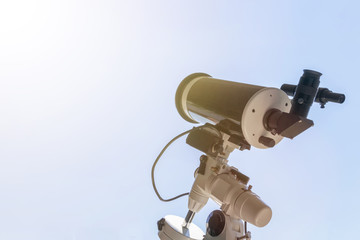 Solar eclipse observing with telescope. Telescope with solar filter.