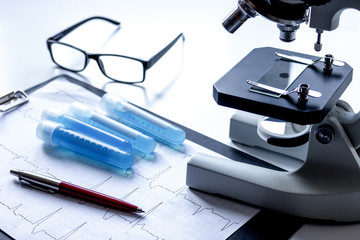 doctors desk with microscope and test tubes