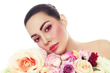 Young beautiful woman with fresh make-up and flowers over white background, copy space