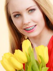 Happy young woman holding tulip bouquet