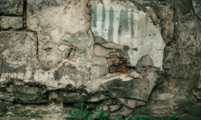Cracked old stone wall background, grunge texture close up.