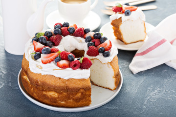 Obraz na płótnie Canvas Angel food cake with whipped cream and berries