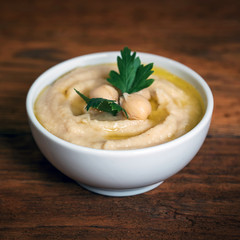 Hummus on a rustic wooden table