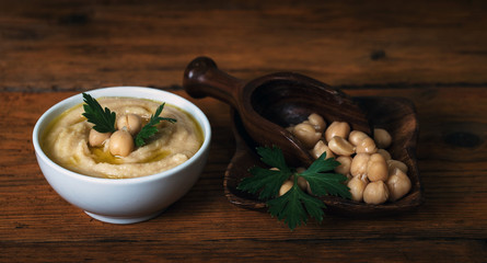 Hummus on a rustic wooden table