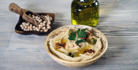 Hummus on a rustic wooden table