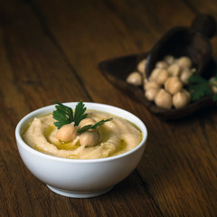 Hummus on a rustic wooden table