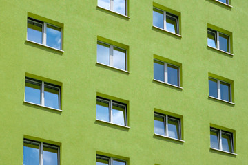 green building exterior , windows on house facade