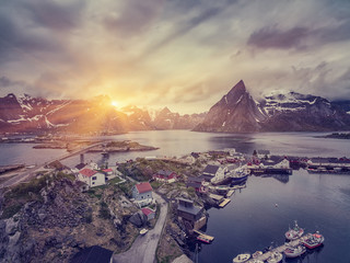 The Typical Norwegian fishing village on the Lofoten in northern Norway Under midnight sun, with...