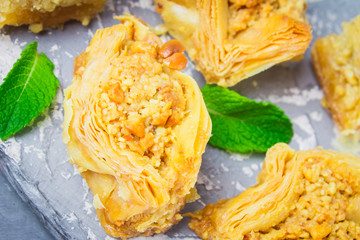 Jewish, turkish, arabic traditional national dessert. Macro. Selective focus. Baklava with honey and nuts
