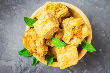 Jewish, turkish, arabic traditional national dessert. Macro. Selective focus. Baklava with honey and nuts
