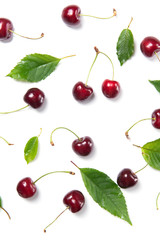 Ripe cherry berries and cherry leaves pattern isolated on white background, top view