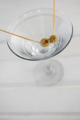 Close up of green olives in vodka martini