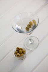 High angle view of olives in container by vodka martini