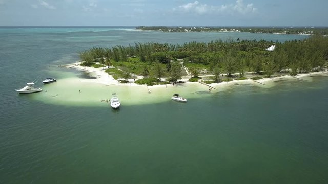 Aerial view of a sandy beach and pleasure boats during a large green algae bloom