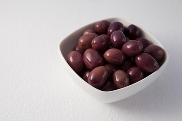 Close up of brown olives in container