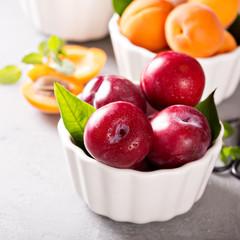 Various fruits in white bowls