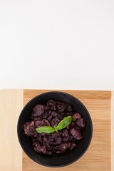 Overhead view of dried olives on cutting board