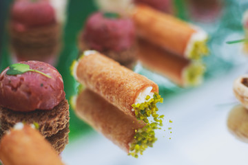 Decorated catering banquet table with different food appetizers assortment on a party
