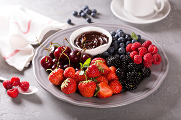 Fresh berries with chocolate sauce for breakfast