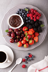 Fresh berries with chocolate sauce for breakfast